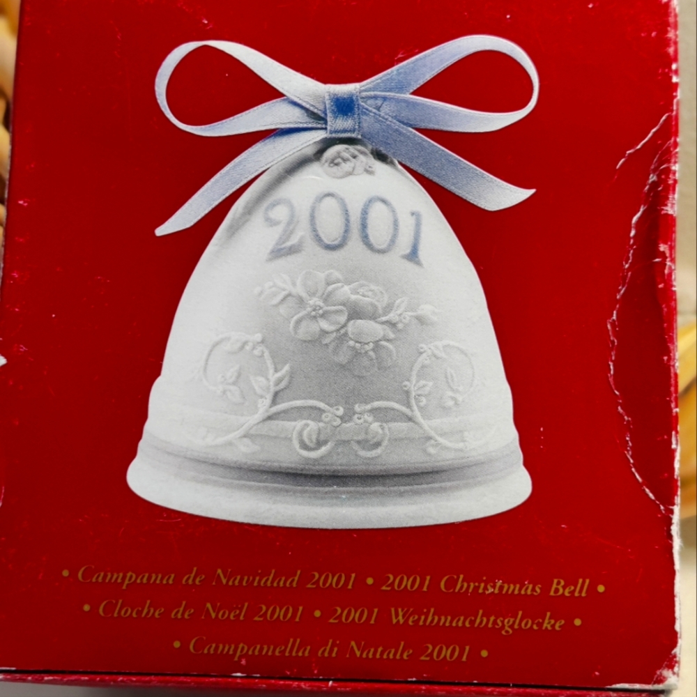 2001 Lladro Christmas bell measuring at 3" x 3" x 3". White with 2001 in blue.